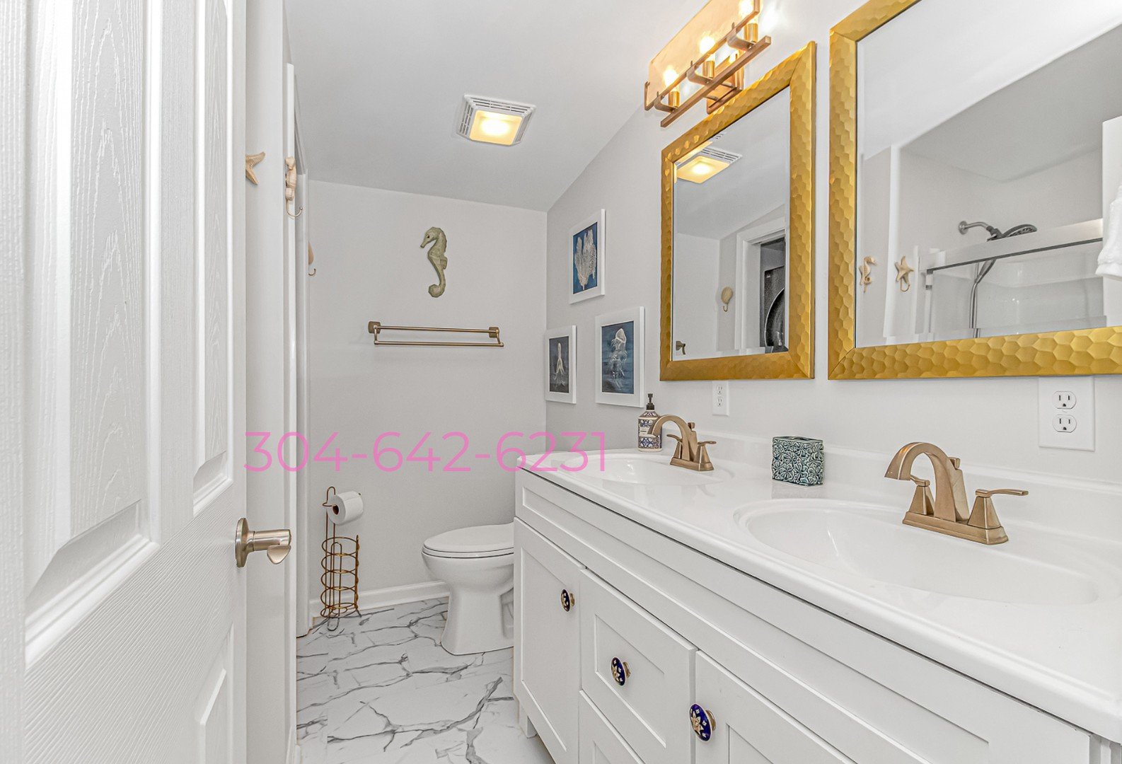 Master bathroom with gold mirrors